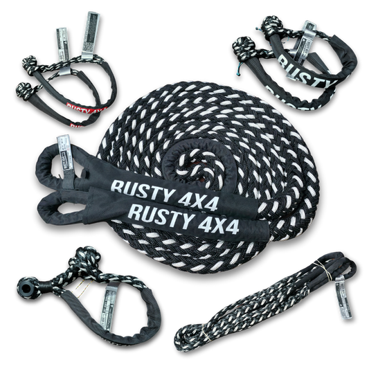 Coiled kinetic recovery rope with black tow straps and metal hooks labeled RUSTY 4X4