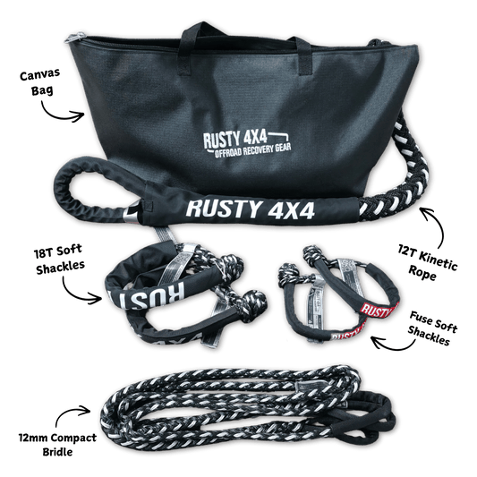 Off-road recovery kit with dark duffel bag, straps, shackles, and braided rope