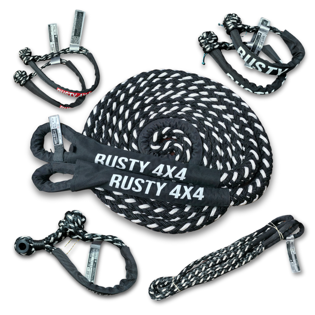 Coiled kinetic recovery rope with black tow straps and metal hooks labeled RUSTY 4X4