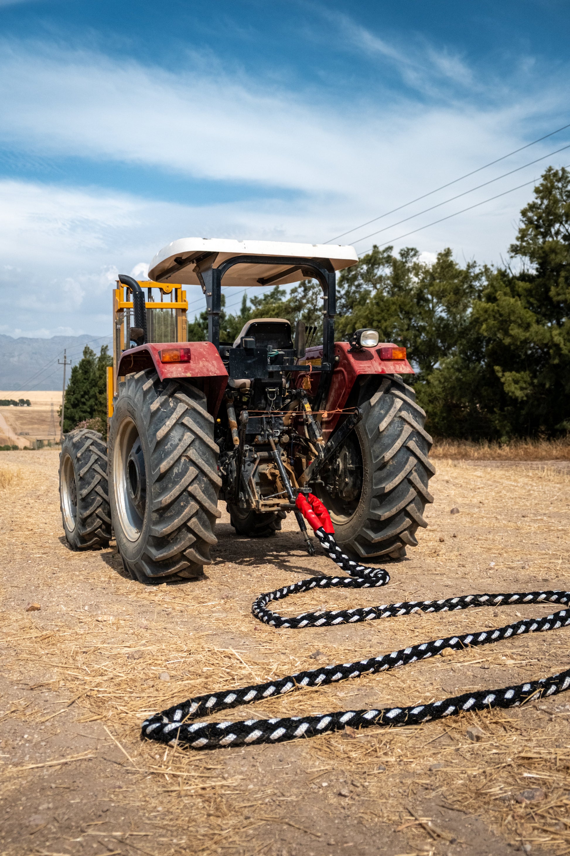 Kinetic recovery rope with black and white braided pattern lying on road