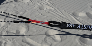 Kinetic recovery rope laid across sand, black ropes with red and white labels
