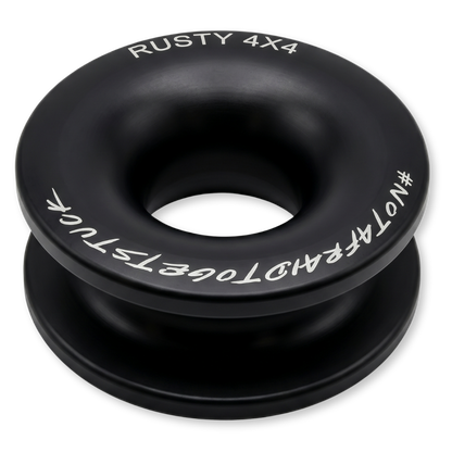 Black winch ring with central hole, white text branding and markings around edge