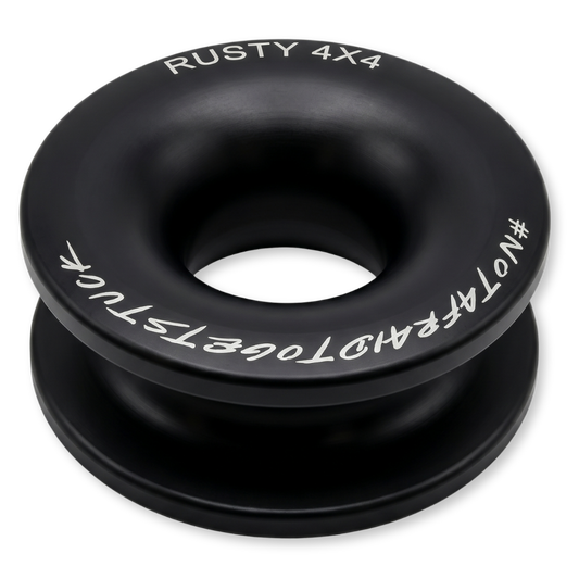 Black winch ring with central hole, white text branding and markings around edge