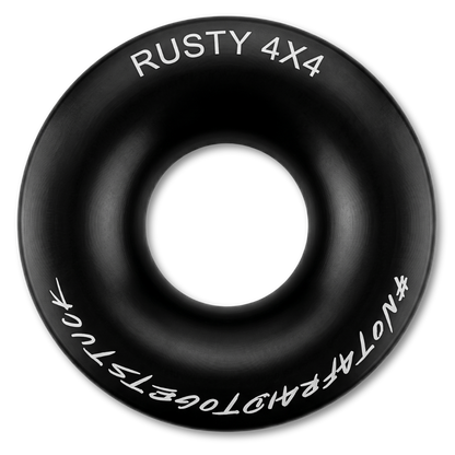 Black winch ring with central hole and white RUSTY 4X4 lettering around edge