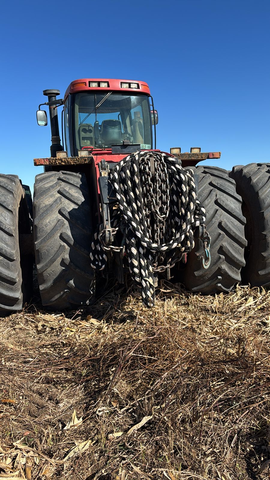 Black-and-white braided kinetic recovery rope coiled on tractor front