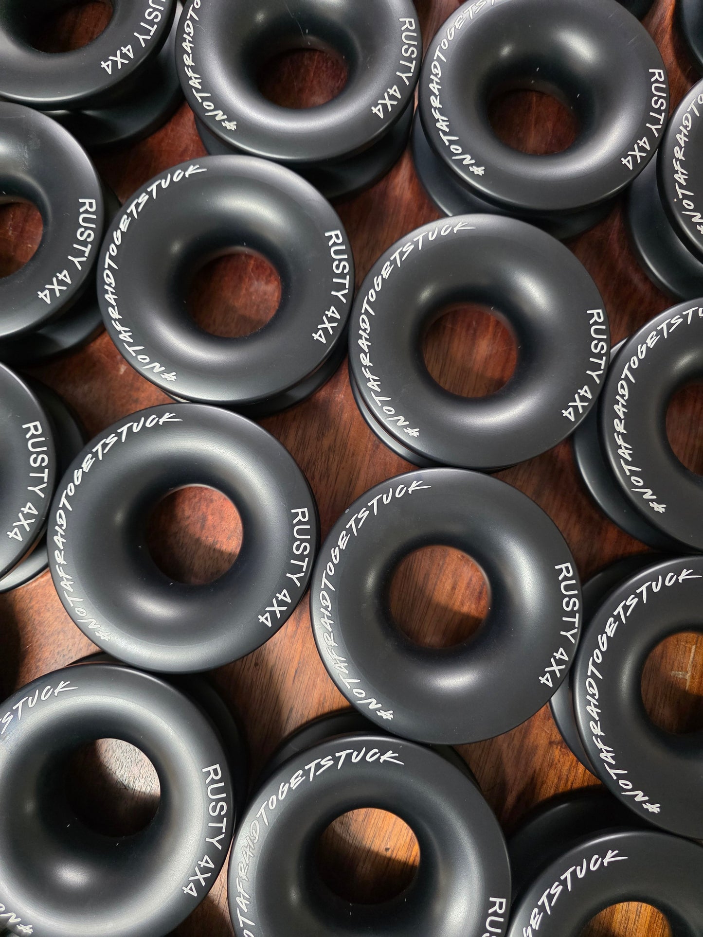 Set of black winch rings with central holes, white markings on each ring